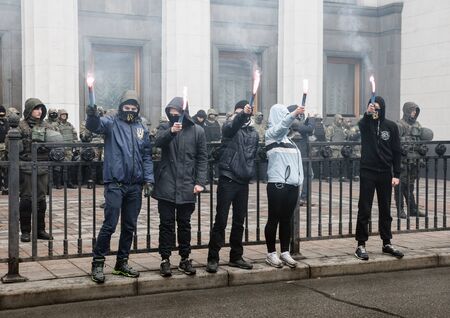 KIEV, UKRAINE - Feb 22, 2017: Activists of nationalist groups burn flares outside the building of the Ukrainian Parliament during the March of National Dignityのeditorial素材