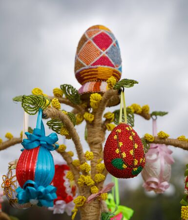 UZHGOROD, UKRAINE - Apr 08, 2017: Folk art and festival of Easter Eggs. Easter holiday. Multicolored Easter eggs hanging on artificial treesのeditorial素材