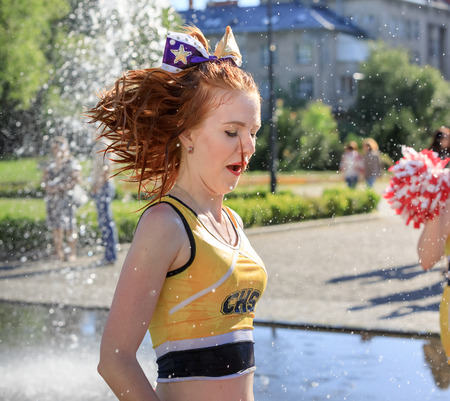 UZHGOROD, UKRAINE - May 28, 2017: Cheerleaders Team. Group of happy Cheerleaders enjoy jogging through the fountain after the performance on the student holidayのeditorial素材