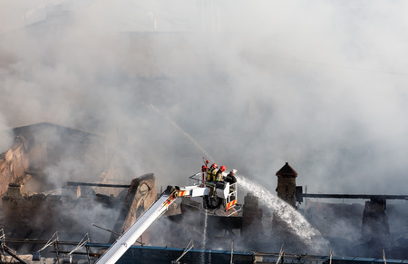 KIEV, UKRAINE - Jun 20, 2017: Ukrainian firefighters try to extinguish a fire in a three-story house on Khreshatyk street, the main street in Kiev. Firefighters in actionのeditorial素材
