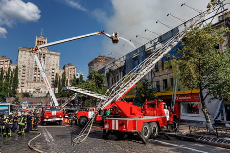 KIEV, UKRAINE - Jun 20, 2017: Ukrainian firefighters try to extinguish a fire in a three-story house...