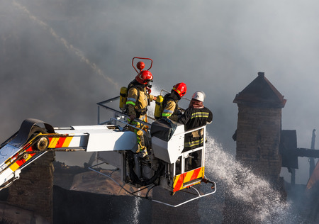 KIEV, UKRAINE - Jun 20, 2017: Ukrainian firefighters try to extinguish a fire in a three-story house...