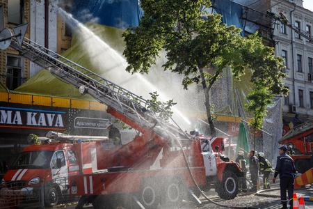 KIEV, UKRAINE - Jun 20, 2017: Ukrainian firefighters try to extinguish a fire in a three-story house on Khreshatyk street, the main street in Kiev. Firefighters in actionのeditorial素材