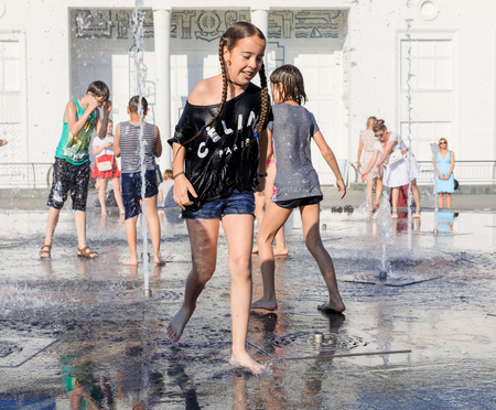KIEV, UKRAINE - Jun 28, 2017: Happy children playing in a water fountain and enjoying the cool streams of water in a hot dayのeditorial素材