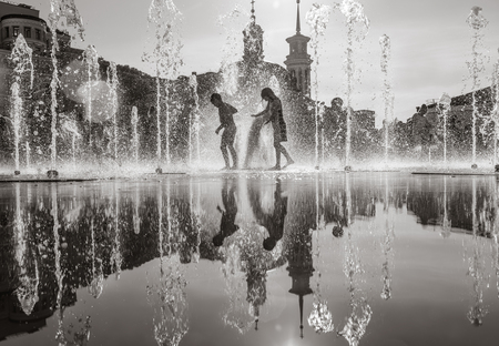 KIEV, UKRAINE - Jun 28, 2017: Happy children playing in a water fountain and enjoying the cool streams of water in a hot dayのeditorial素材