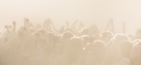 High key background with a picture of a crowd of people on an open playground at a concert. Abstract soft focus image with copy spaceの写真素材