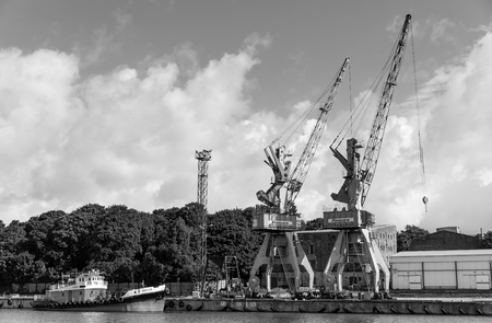 LIEPAJA, LATVIA - JUN 26, 2017: Liepaja seaport with port cranes.のeditorial素材