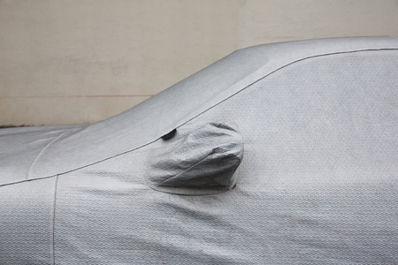 New York City street scene. Car Protection Cover. A car with cover sheet on the streets of NYCの写真素材