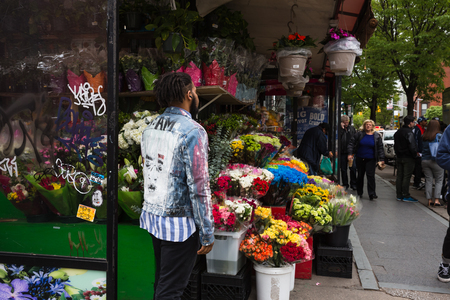 NEW YORK, USA - May 05, 2016: Manhattan street scene. Bedford fruits and vegetables shop. New Yorkers in Manhattan in a hurry about their business.のeditorial素材