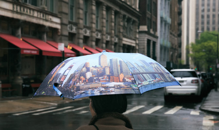 NEW YORK, USA - May 03, 2016: Manhattan street scene. Woman with an umbrella in the streets of New York City on a rainy overcast dayのeditorial素材