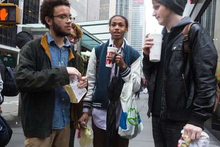 NEW YORK, USA - May 03, 2016: Manhattan street scene. Teenagers with food and drink from fast food communicate on the streets of Manhattanのeditorial素材