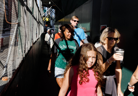 NEW YORK, USA - Sep 17, 2017: Light and shadows on Manhattan streets. Americans on the streets of New York City walking on sidewalk with a protective fence near construction worksのeditorial素材