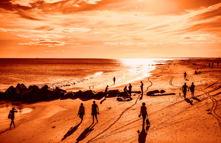 NEW YORK, USA - Sep 23, 2017: Coney Island Beach in New York City. A group of people is resting on the beach. Coney Island is well known as the site of amusement parks and a seaside resortのeditorial素材