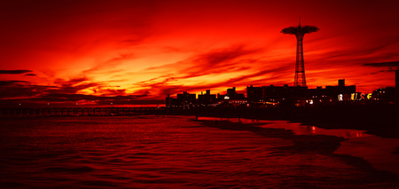 NEW YORK, USA - Sep 23, 2017: Coney Island Beach in New York City. Silhouettes of Parachute Jump tower on a sunset backgroundのeditorial素材