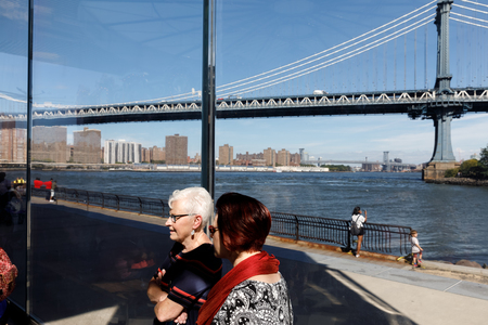 NEW YORK, USA - Sep 23, 2017: Manhattan street scene. Two elderly women on the background of the Manhattan bridgeのeditorial素材