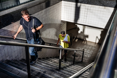 NEW YORK, USA - Sep 23, 2017: Manhattan street scene. Light and shadows in New York City. Man comes out of NYC subway station.のeditorial素材