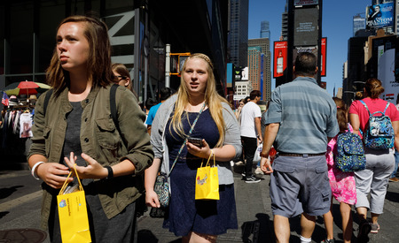 NEW YORK, USA - Sep 23, 2017: Manhattan street scene. New Yorkers and tourists in a hurry about...