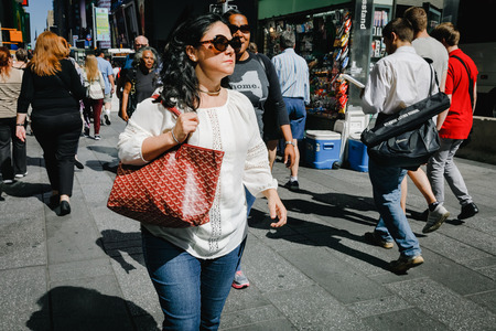 NEW YORK, USA - Sep 23, 2017: Manhattan street scene. New Yorkers and tourists in a hurry about their business, walking and relaxing on Times Square in NYCのeditorial素材