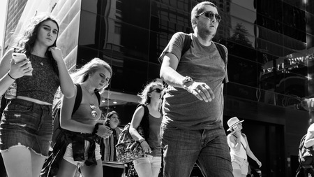 NEW YORK, USA - Sep 23, 2017: Manhattan street scene. New Yorkers and tourists in a hurry about...