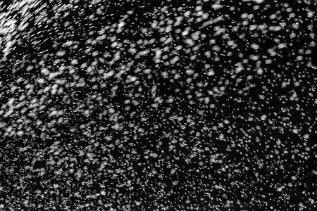 Rain on black. Abstract splashes of water on a black background for screen blending mode and photo retouching.の写真素材