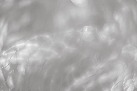 Abstract blurred background. Beautiful lines and light spots of blurred metal net with defocused bokehの写真素材