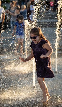 KIEV, UKRAINE - Jun 05, 2018: Cheerful and happy children playing in a water fountain and enjoying the cool streams of water in a hot day. Hot summer.のeditorial素材