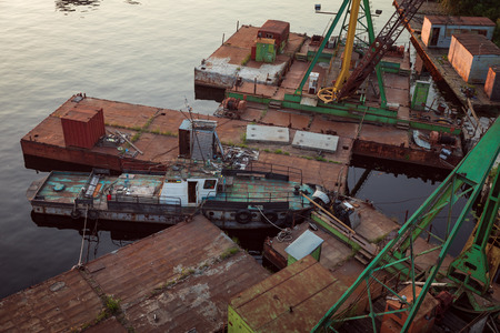 KIEV, UKRAINE - May 30, 2018: Industrial district of Kiev in Podil district. Dnieper and the river port. View from cable-stayed Rybalsky bridge in the evening during sunsetのeditorial素材