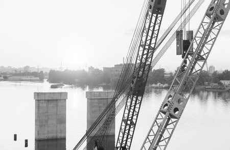 KIEV, UKRAINE - May 30, 2018: Industrial district of Kiev in Podil district. Dnieper and the river port. View from cable-stayed Rybalsky bridge in the evening during sunsetのeditorial素材