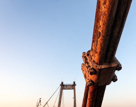 KIEV, UKRAINE - May 30, 2018: Rusty fragment of cable-stayed Rybalsky bridge in the evening during sunset. Industrial district of Kiev, Ukraineのeditorial素材