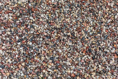 Different colored rocks and pebbles on a beach. Various colors and texturesの写真素材