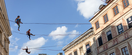Lublin, Poland - Jul 27, 2018: Rope walkers at urban highline festival placed in city space of Lublin. Lublin is the ninth largest city in Poland.のeditorial素材