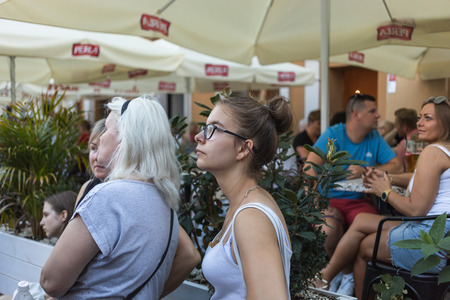 Lublin, Poland - Jul 27, 2018: Crowds of tourists and holidaymakers on the streets of the old city of Lublin. Group of people in a street cafe. Lublin is the ninth largest city in Polandのeditorial素材