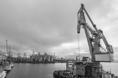 Odessa, Ukraine - Sep 10, 2018: Marine Industrial Commercial Port. Industrial zone of Odessa sea port. Container cranes. Cargo container terminal of sea freight industrial port.のeditorial素材