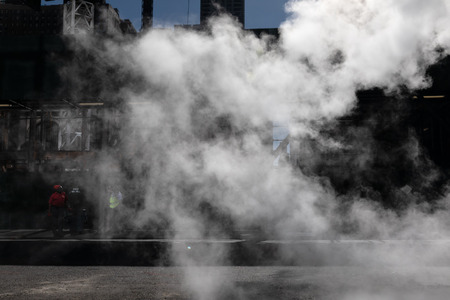 NEW YORK, USA - Sep 23, 2017: Manhattan street scene. Cloud of vapor from the subway on the streets of Manhattan in NYC. Typical view of Manhattanのeditorial素材