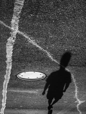 Light and shadows in New York City. Shadows of people walking street in morning lightの写真素材