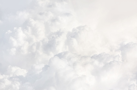 Sky with clouds, a view from an aeroplane above the clouds. Abstract nature background with clouds in light tonality. White cumulus cloudsの写真素材