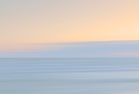 Abstract blurred sea landscape and cloudy sky background in light tonality with copy space