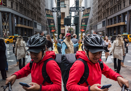 New York, USA - Sep 24, 2018: Manhattan reflections street scene. New York and New Yorkers reflected...