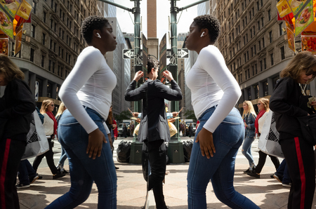 New York, USA - Sep 24, 2018: Manhattan reflections street scene. New York and New Yorkers reflected...