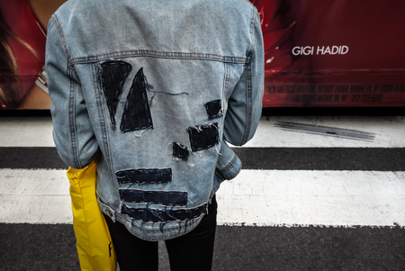 New York, USA - Sep 24, 2018:  Manhattan street scene. Manâ€™s back view in a denim jacket with...