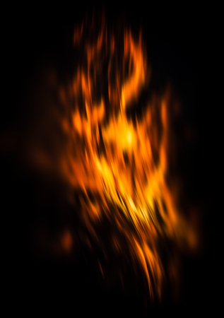 Blurred fire flames of a campfire at night. Fire flames on a black backgroundの写真素材