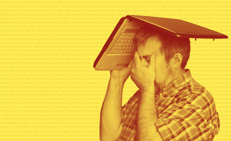 Digital world concept. Duotone yellow red image. Problems with computer. Middle aged stressed man...
