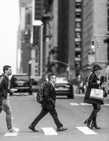 NEW YORK, USA - May 04, 2016: Black and white image of Manhattan street scene. Young men and woman...