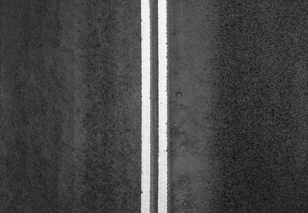 Black and white road markings on asphalt on the street of Manhattan in New York Cityの写真素材