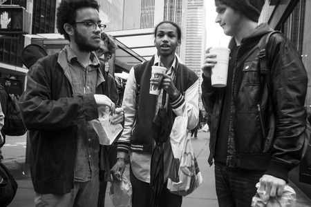 NEW YORK, USA - May 03, 2016: Black and white Manhattan street scene. Teens discuss their problems on the streets of New Yorkのeditorial素材