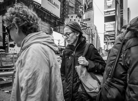 NEW YORK, USA - May 03, 2016: Black and white image of Manhattan street scene. New Yorkers and tourists walking on Times Square in New York Cityのeditorial素材