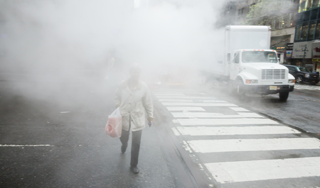 NEW YORK, USA - May 03, 2016: Manhattan street scene. Cloud of vapor from the subway on the streets of Manhattan in NYC. Typical view of Manhattanのeditorial素材