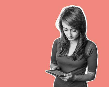 Education and lifestyle concept. Young woman using a digital tablet. Modern gadget in hand. Magazine...