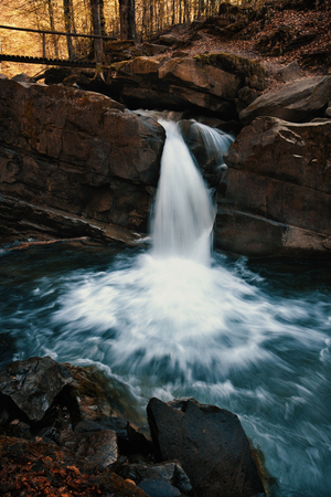 Mountain stream in forest at spring time. Landscape with waterfall, rocks and flowing water. Waterfall and forest stream in the Carpathian mountains. Ukraine. Europeの写真素材