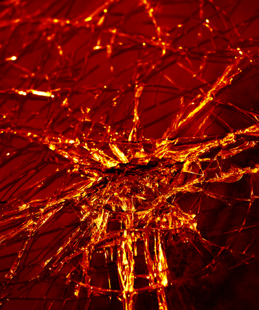 Broken glass texture. Close-up broken car windshield. Broken and damaged car. Tint redの写真素材